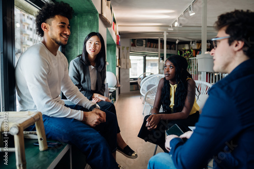 Young male and female business team having informal meeting
