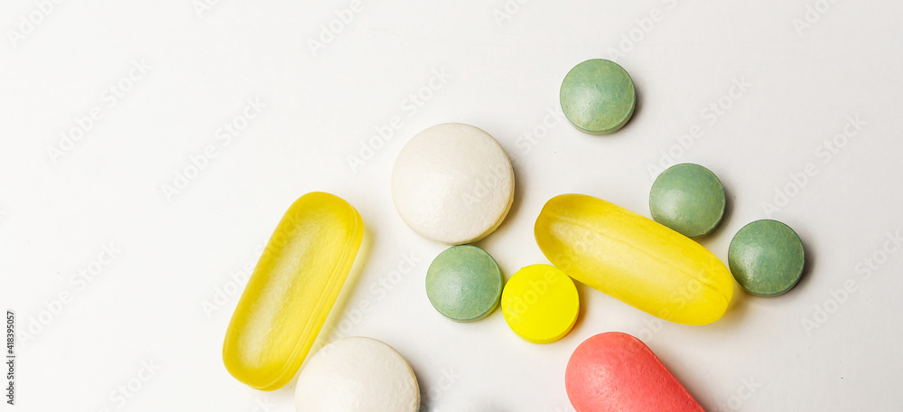 Colorful pills vitamins and antibiotics lie beautifully on a white background Colorful pills vitamins and antibiotics lie beautifully on a white background