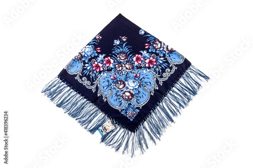 top view flat lay on folded dark blue cotton scarf with fringe and floral ornament photo