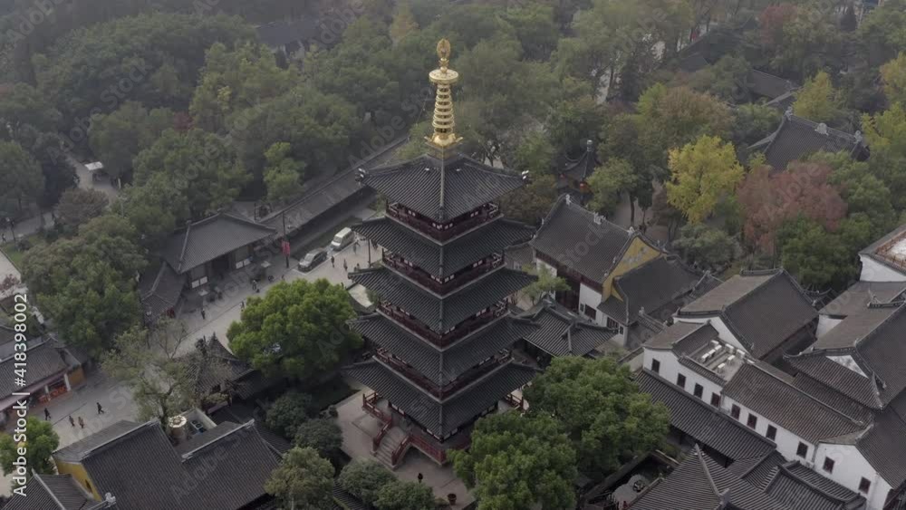 Aerial panning shot of people at Hanshan Temple Buddhist Library near river, drone flying over buildings in city - Suzhou, China Aerial panning shot of people at Hanshan Temple Buddhist Library near river, drone flying over buildings in city - Suzhou, China