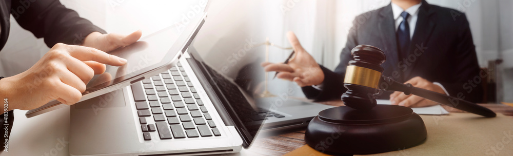 Business and lawyers discussing contract papers with brass scale on desk in office. Law, legal services, advice, justice and law concept picture with film grain effect Business and lawyers discussing contract papers with brass scale on desk in office. Law, legal services, advice, justice and law concept picture with film grain effect