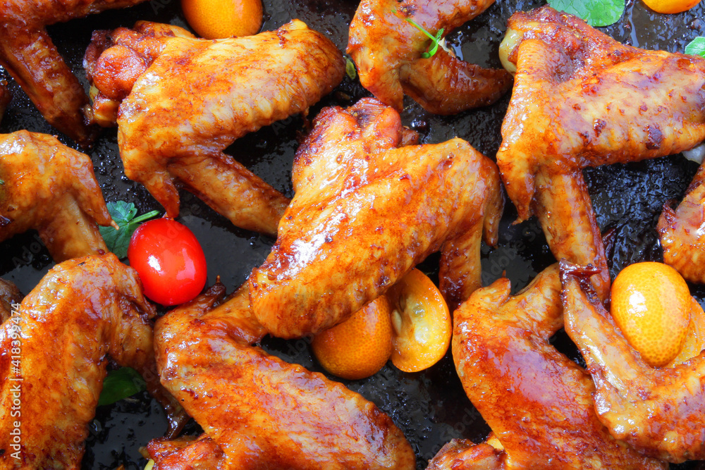 fried barbecue chicken wings marinated in spices with hot pepper and lemon.