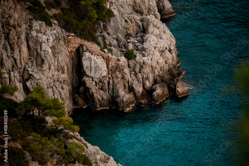 close-up of rocky cliff by Mediterranean Sea bay