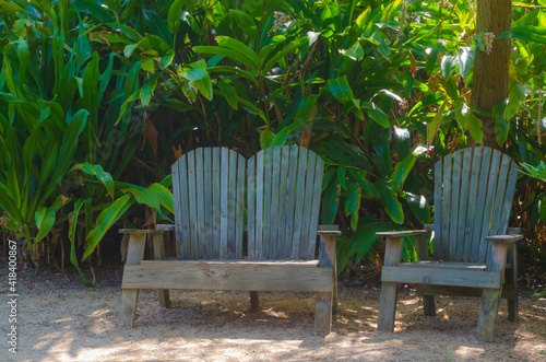 USA, Florida. Tropical garden with chairs.