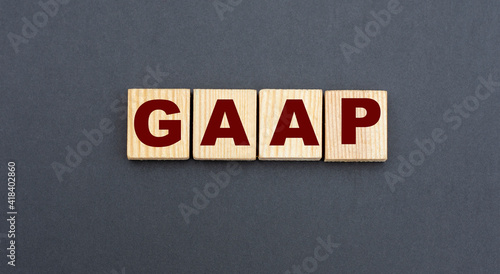 concept acronym GAAP on wooden cubes on a gray background photo