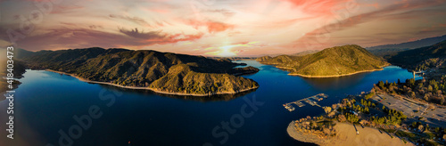 a majestic aerial panoramic of the vast blue still lake water with breathtaking mountain ranges reflecting off the lake at sunset at Silverwood Lake in Hesperia in San Bernardino County California photo
