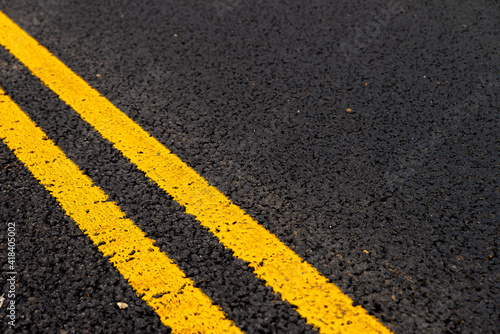 Asphalt background with yellow lines