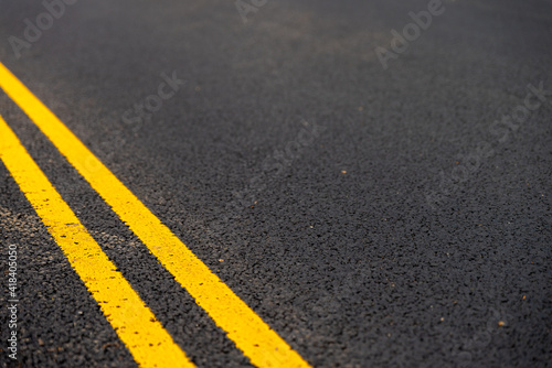 Asphalt background with yellow lines