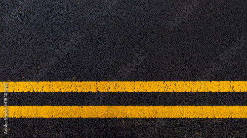 Asphalt background with yellow lines
