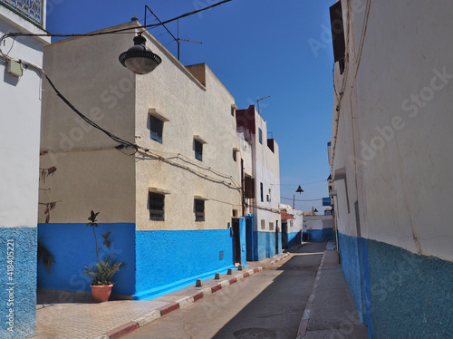 Mediterranean style white and blue moody streets. Old town in Rabat, the capital city of Morocco with characteristic white and blue walls paintings in narrow streets.  © Natalia