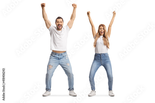 Young man and woman in jeans and white t-shirts gesturing happiness with raised arms