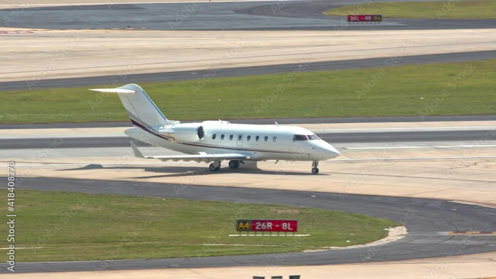 Generic Unmarked Modern Executive VIP Business Jet Private Airplane Taxiing from International Airport Runway after Landing on a Sunny Day Generic Unmarked Modern Executive VIP Business Jet Private Airplane Taxiing from International Airport Runway after Landing on a Sunny Day