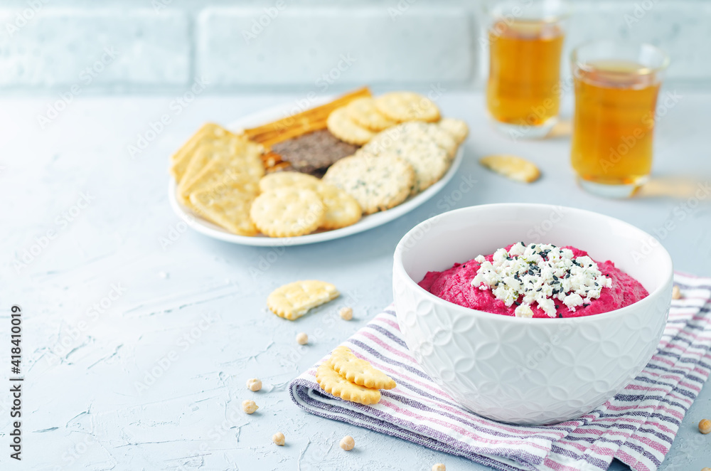 Beet hummus with Feta and black sesame in a bowl Beet hummus with Feta and black sesame in a bowl