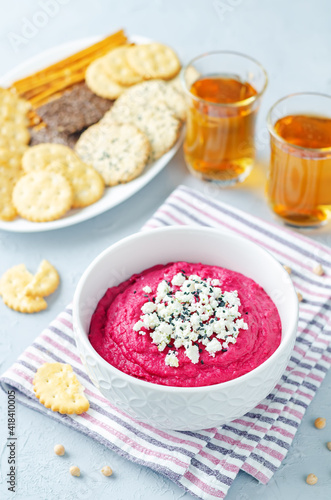 Beet hummus with Feta and black sesame in a bowl