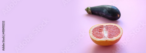 Oblong banner of a grapefruit and eggplant, symbols for the female and male gender