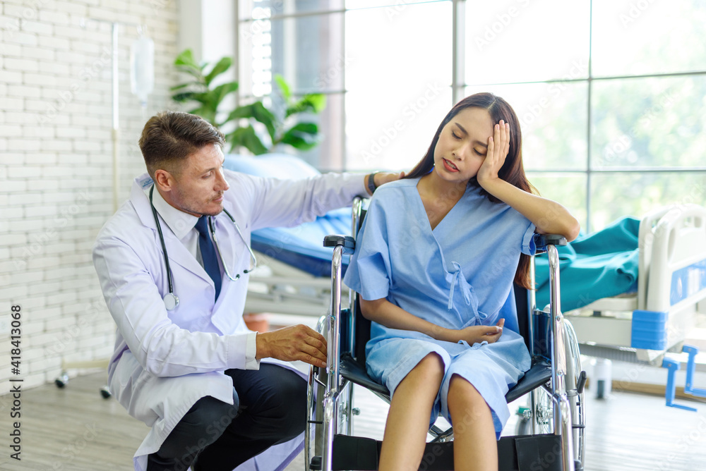 Working women have a headache on a wheelchair inside the clinic.