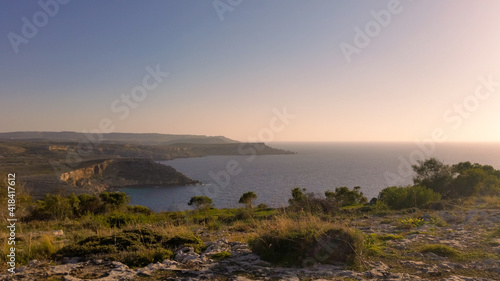 Pink sunset at the cliffs of Anchor Bay, Malta