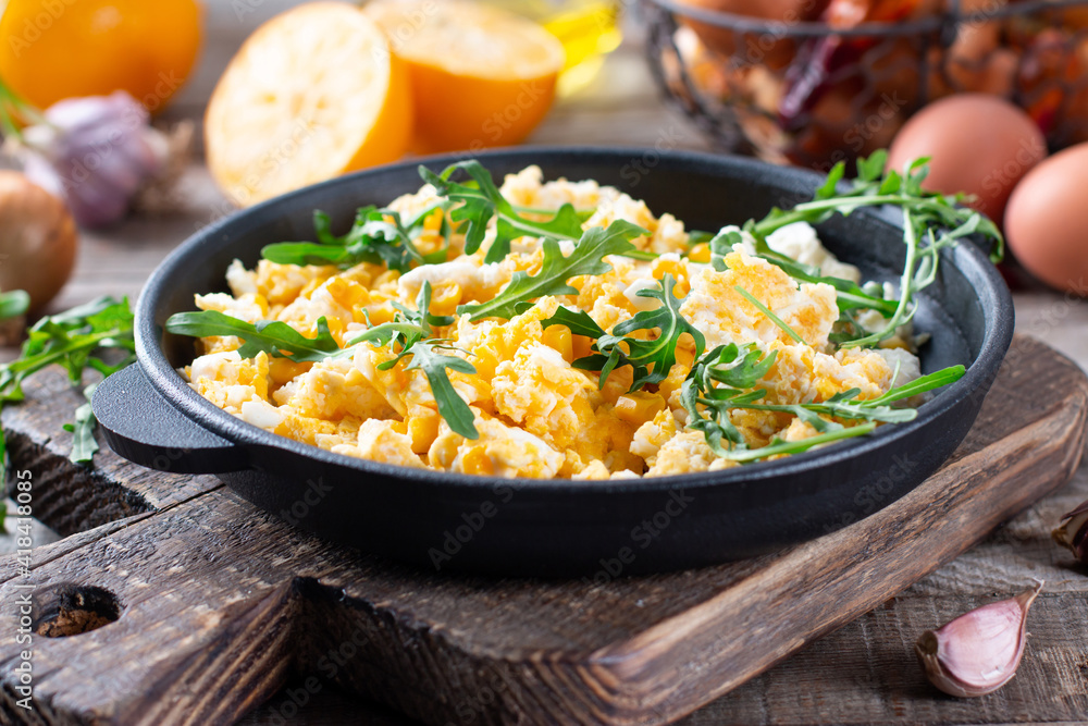 Scrumble eggs with corn, cream cheese sauce, herbs and vegetable served in cast iron skillet. Scrumble eggs with corn, cream cheese sauce, herbs and vegetable served in cast iron skillet.