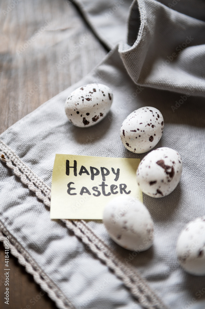 Easter theme. White eggs in a speck, a note with the words Easter theme. White eggs in a speck, a note with the words