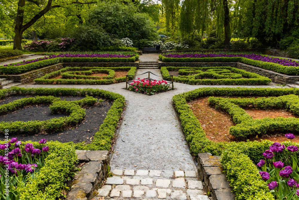 Small square in park with plants in card symbols shape Small square in park with plants in card symbols shape
