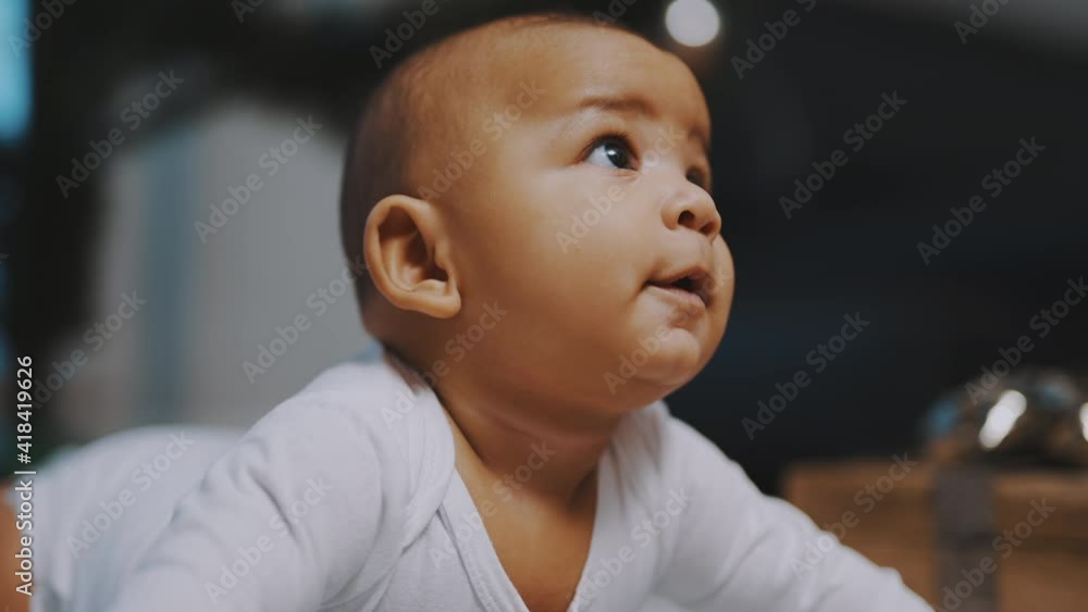 Portrait of adorable african american black baby. Baby laughing while having tummy time. Slow motion. High quality 4k footage Portrait of adorable african american black baby. Baby laughing while having tummy time. Slow motion. High quality 4k footage