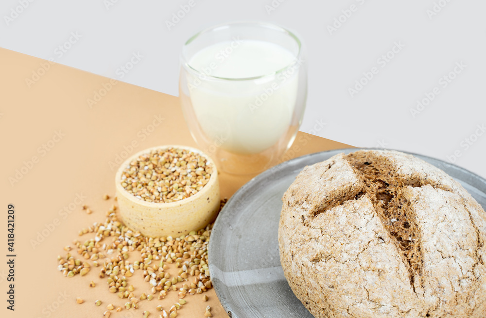 Isometry diagonal projection creative beige background with green buckwheat bread nd organic buckwheat milk. Harmless, wellness, gluten free healthy baking. Alternative bread. Copy spase Isometry diagonal projection creative beige background with green buckwheat bread nd organic buckwheat milk. Harmless, wellness, gluten free healthy baking. Alternative bread. Copy spase
