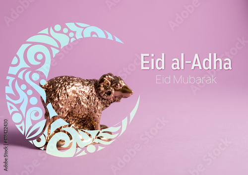 Golden lamb figure decorated with ornamental Crescent Moon on a purple background. Sheep of Eid al-Adha Mubarak or Feast of Sacrifice Kurban Bairam. photo