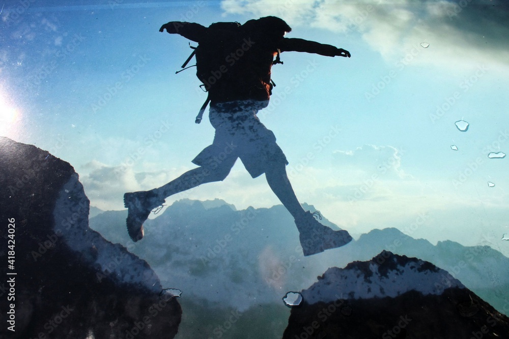 jumping over mountains, illustration shows man in the alps jumping over the mountain peaks