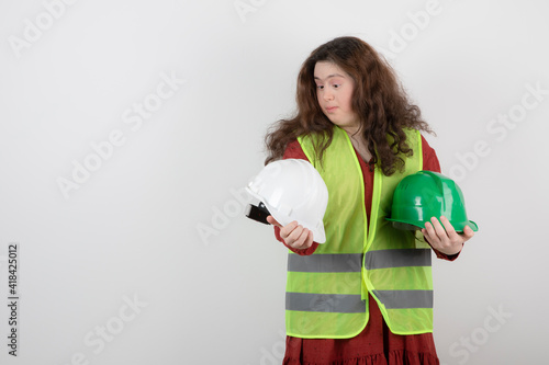 Image of a young cute girl with down syndrome standing in vest