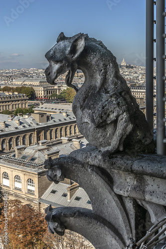Famous Stone demons gargoyle and chimera with Paris city on background. View from Notre Dame de Paris. France. 