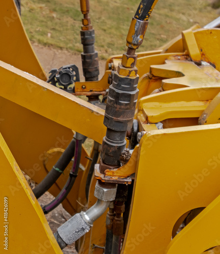 Hydraulic system with valves and actuators on earth moving equipment; hydraulic lines