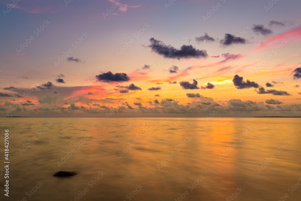 The golden colors of sunset reflecting off the Gulf waters in Florida