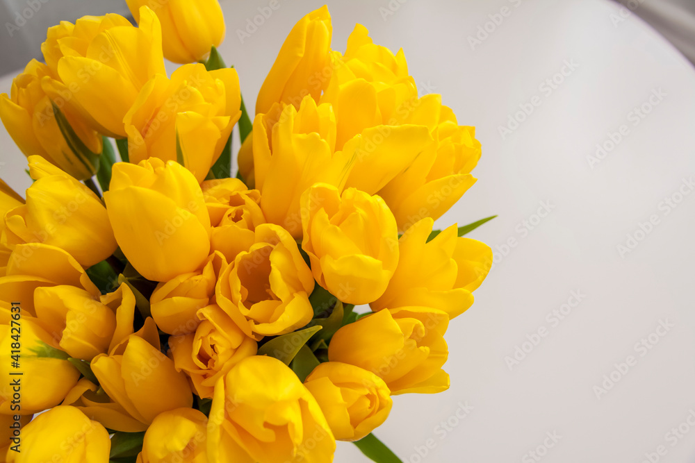 A bouquet of fresh yellow tulips. Bouquet of tulips on the table, top view. Spring flowers in the interior. The concept of spring or holiday, March 8, International Women's Day, A bouquet of fresh yellow tulips. Bouquet of tulips on the table, top view. Spring flowers in the interior. The concept of spring or holiday, March 8, International Women's Day,