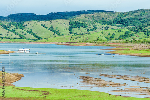 Lake of Furnas at Capitólio MG, Brazil. Landscape view of a beautiful lake with boat deck and mountains on background. Brazilian tourism destination, natural beauty of Minas Gerais state. photo