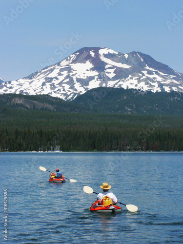 Kayaking on Elk Lake, Oregon - Two kayakers are enjoying the calm waters on Elk Lake, Oregon with Mt Bachelor in the background © James Cottingham