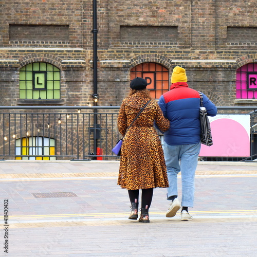 Hipster couple walking in the street . central London, february 2021