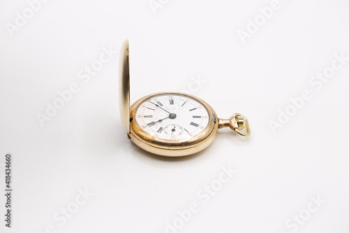 vintage golden pocket watch isolated on white background.