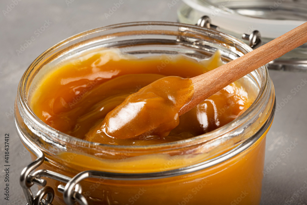 Close-up of jar full of dulce de leche. Dulce de leche, traditional sweet in Latin America. Close-up of jar full of dulce de leche. Dulce de leche, traditional sweet in Latin America.