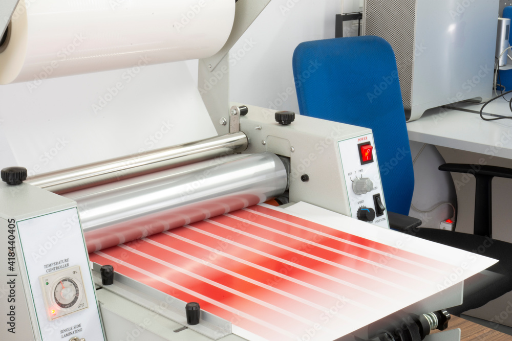 Fototapeta premium China-made Thermal cellophane machine in operation and details. 33 cm widht