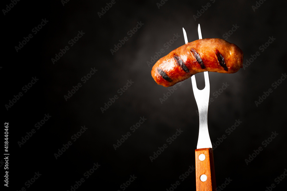 Grilled barbecue sausages on dark background. - obrazy, fototapety, plakaty 