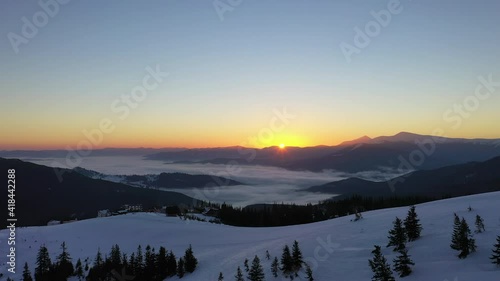 Wallpaper Mural dawn in the snow-capped mountains, the first rays of the sun break through from behind the mountain peaks above the clouds Torontodigital.ca