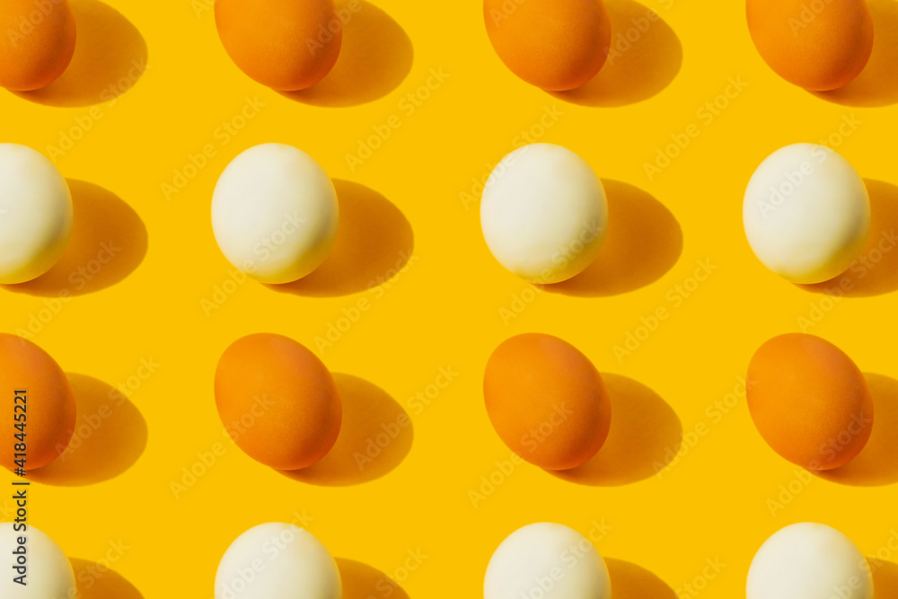 Farm chicken fresh and boiled eggs pattern on yellow background with copy space. Healthy food or Happy Easter creative minimal concept. Flat lay Farm chicken fresh and boiled eggs pattern on yellow background with copy space. Healthy food or Happy Easter creative minimal concept. Flat lay