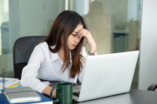 Cropped shot of businesswoman headache while working with laptop in the office.
 photo