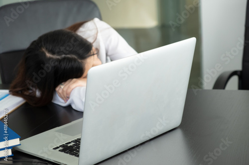 Cropped shot of businesswoman headache while working with laptop in the office.
 photo