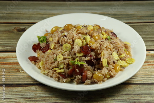 Traditional fried and stirred cooked rice with gingko and roasted pork sausage serving on the plate. Famous special rice menu in Chinese restaurant. 