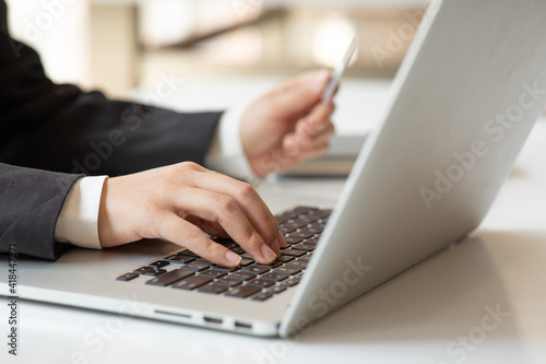 Close up of business hand working with laptop and credit card at home , paying,payment,buying and online shopping concept.