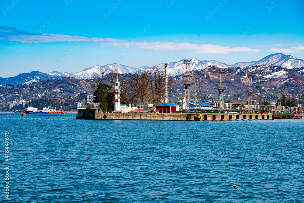 View of the lighthouse from the shore in the seaport of the city of Batumi, Adjara, Georgia