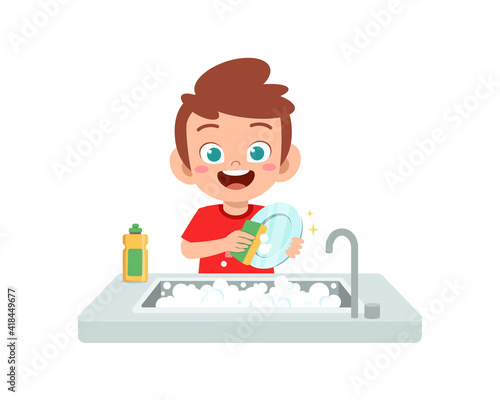 happy cute little boy washing dish in the kitchen