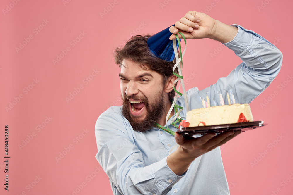 Bearded man with cake on pink background birthday party corporate emotions model loneliness Bearded man with cake on pink background birthday party corporate emotions model loneliness