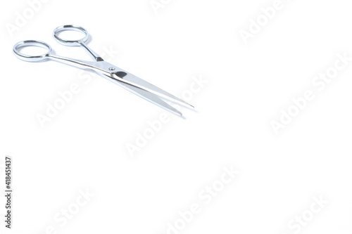Silver metal scissors for haircut on white background.